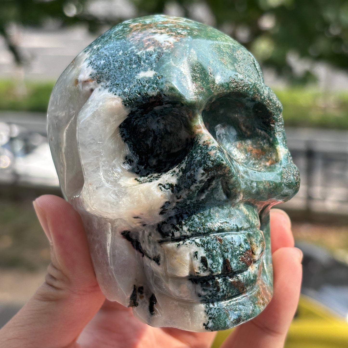 "Handcrafted Moss Agate Skull - Mystical and Delicate Crystal Carving"