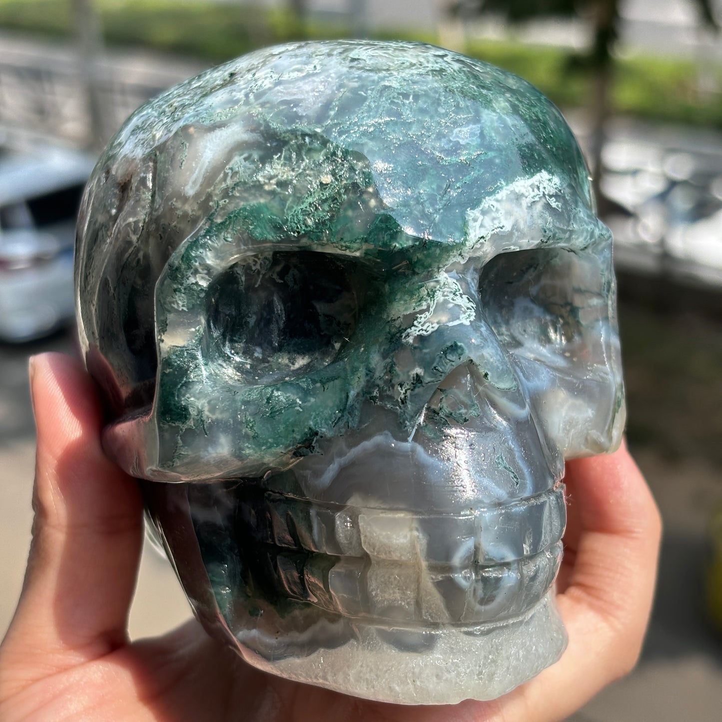 "Handcrafted Moss Agate Skull - Mystical and Delicate Crystal Carving"