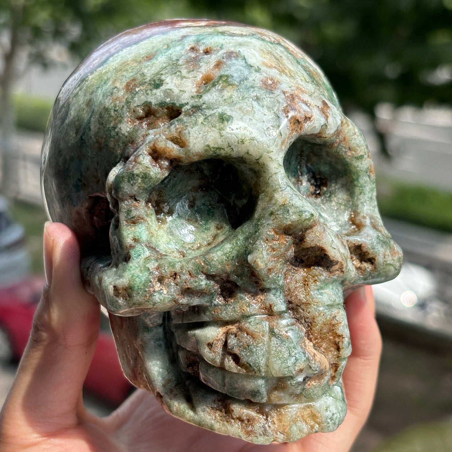"Handcrafted Moss Agate Skull - Mystical and Delicate Crystal Carving"