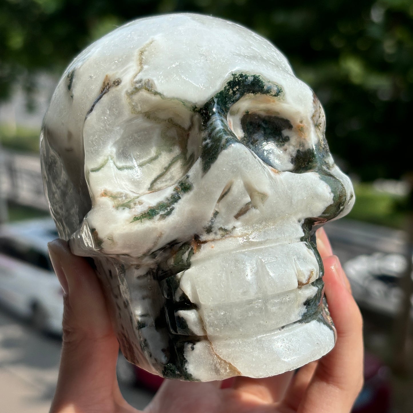 "Handcrafted Moss Agate Skull - Mystical and Delicate Crystal Carving"