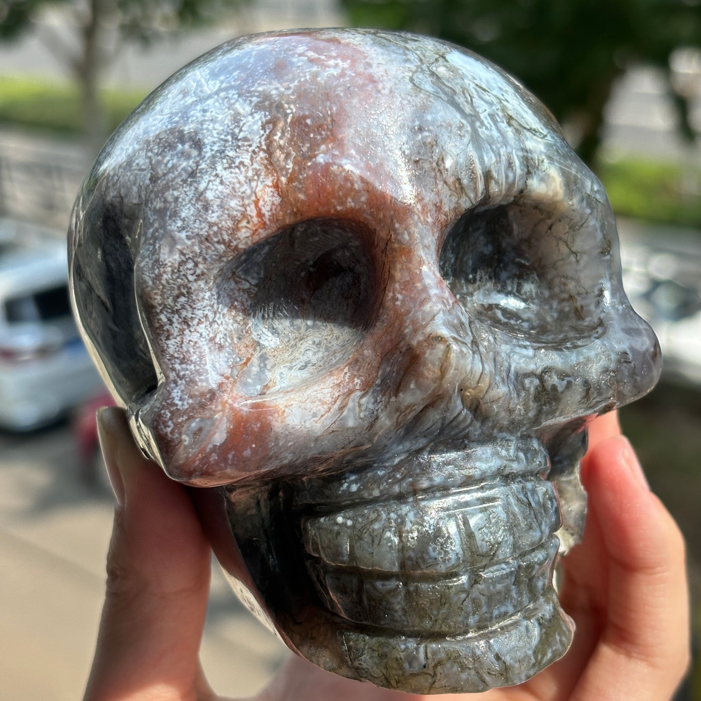 "Handcrafted Moss Agate Skull - Mystical and Delicate Crystal Carving"