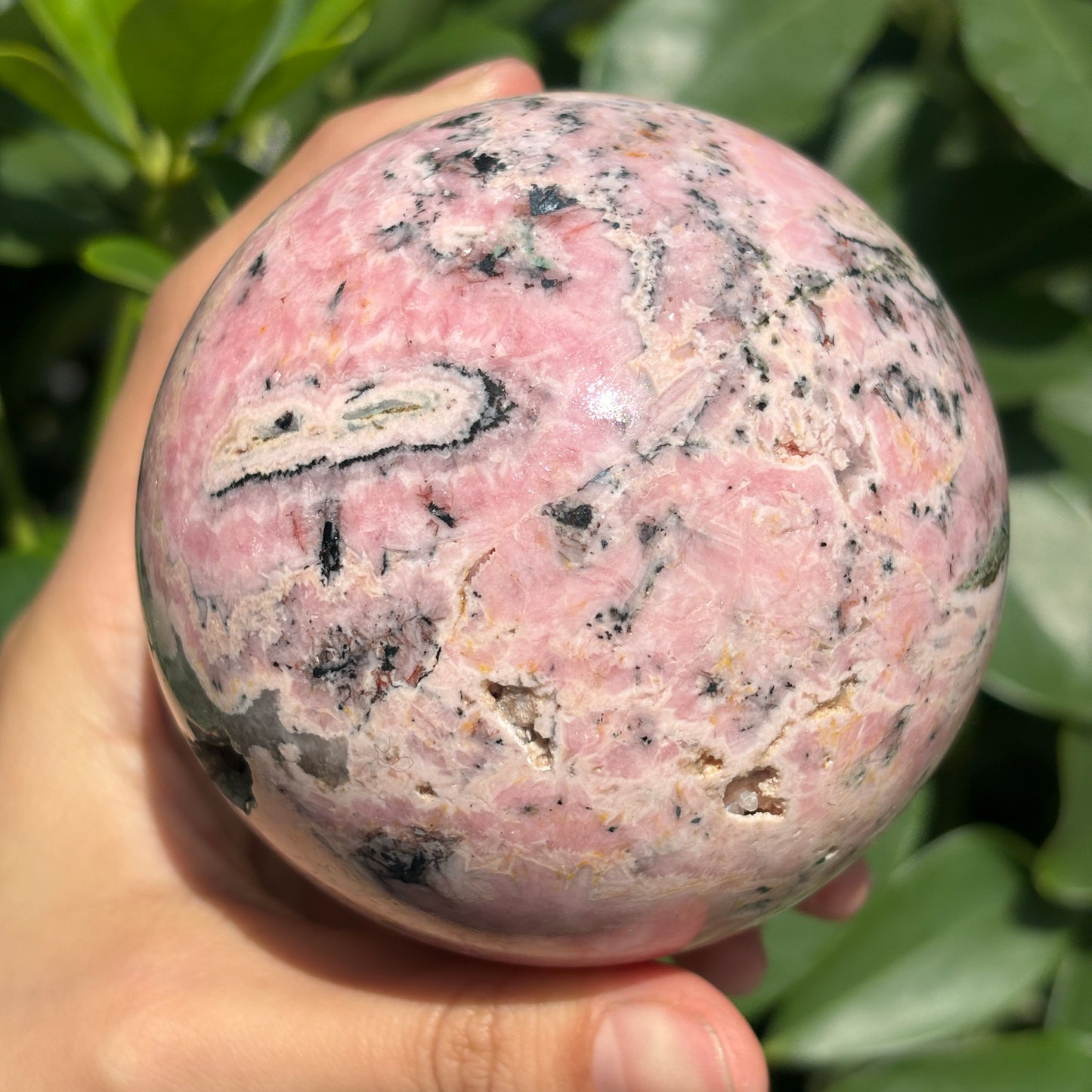 "Natural Rhodonite Crystal Sphere – Harmonious Pink Elegance"